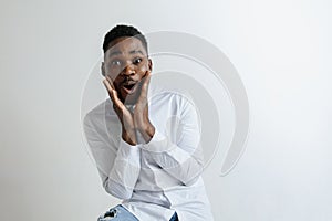 Portrait of excited young African American male screaming in shock and amazement.