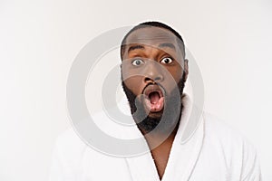 Portrait of excited young African American male screaming in shock and amazement holding hands on head. Surprised black