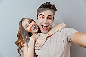 Portrait of an excited young couple hugging
