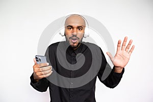 Portrait of excited young man with mobile phone waving hand