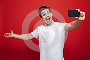 Portrait of an excited young man in white t-shirt