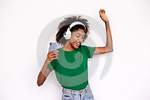 Portrait of excited young woman dancing in headphones