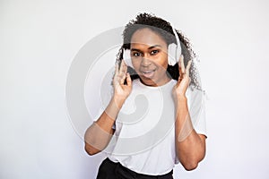 Portrait of excited young woman listening to music in headphones