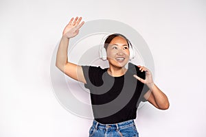 Portrait of excited young woman listening to music and singing