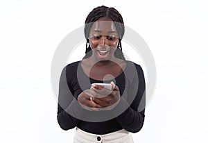 Portrait of excited young woman reading news on smartphone
