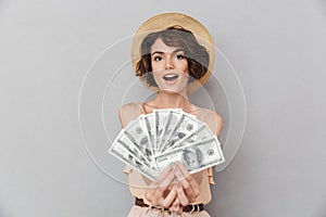 Portrait of an excited young woman in summer hat