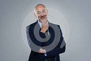 Excutive businessman wearing suit and standing against at isolated background photo