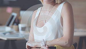 Portrait of an executive professional mature businesswoman sitting on office desk