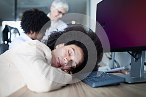 Portrait of an exhausted business woman sleeping at work