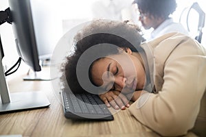 Portrait of an exhausted business woman sleeping at work
