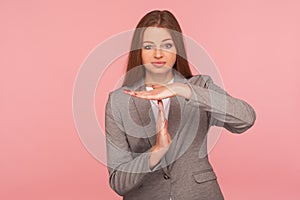 Portrait of exhausted woman in business suit showing time out gesture, looking tired, asking more time for job