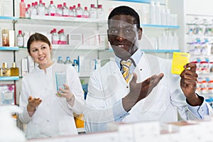 Portrait of experienced male pharmacist counseling about medicines in pharmacy