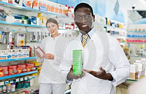 Portrait of experienced male pharmacist counseling about medicines in pharmacy
