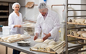 Portrait of experienced professional baker during daily work in kitchen of small bakeshop