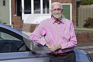 Portrait Of Experienced Senior Male Driver Standing Next To Car