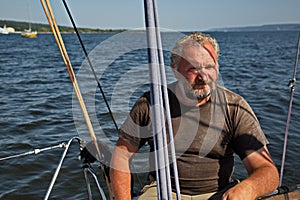 Portrait of an experienced yachtsman driving a yacht.