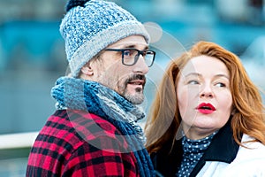 Portrait of expression couple talked on street. Couple looked at strangers.