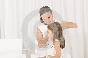 Portrait of expressive beautiful little girl and her mother