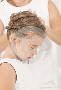 Portrait of expressive beautiful little girl and her mother