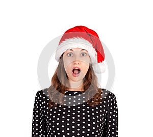 Portrait of expressive shocked and surprised woman. emotional girl in santa claus christmas hat isolated on white background. holi