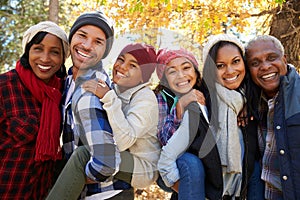 Portrait Of Extended Family On Walk Through Woods In Fall