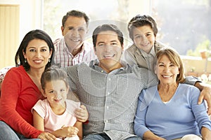 Portrait Of Extended Hispanic Family Relaxing At Home