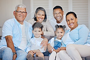 Portrait of extended hispanic family sitting together at home. Happy family with two children, parents and grandparents