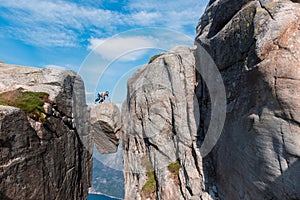 Portrait of a extreme plan travel for the handsome old man on the stone of the kjerag in the mountains of Norway, s