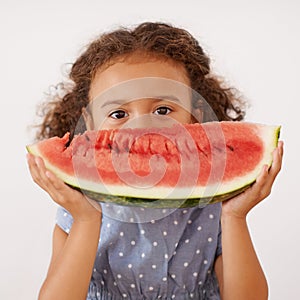 Portrait, eyes or girl with watermelon in studio for healthy, diet or wellness on grey background. Fruit, hiding or kid