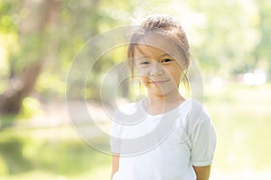 Portrait face of cute asian little girl and child happiness and fun in the park in the summer
