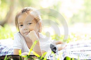 Portrait face of cute asian little girl and child happiness and fun in the park in the summer,