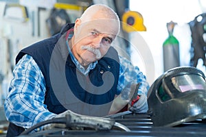portrait factory senior welder worker on manufacture workshop