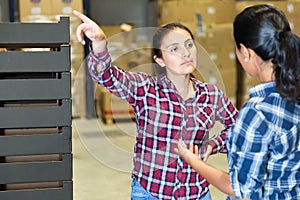 Portrait of factory warehouse manager instructs worker