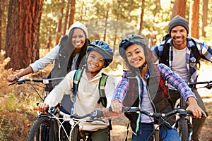 Portrait Of Family Cycling Through Fall Woodland