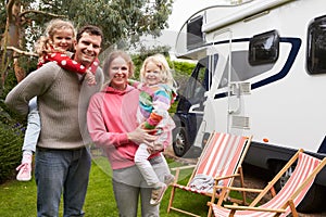 Portrait Of Family Enjoying Camping Holiday In Camper Van