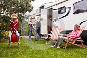 Portrait Of Family Enjoying Camping Holiday In Camper Van photo