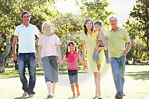 Portrait Of Family Enjoying Walk In Park