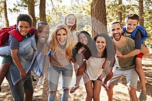 Portrait Of Family With Friends On Hiking Adventure In Forest