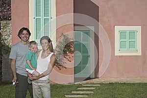 Portrait Of Family In Front Of House