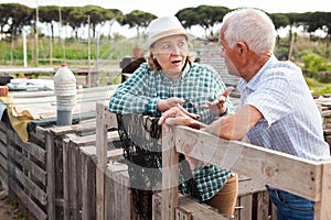 Portrait of family of gardeners near wooden girders in garden