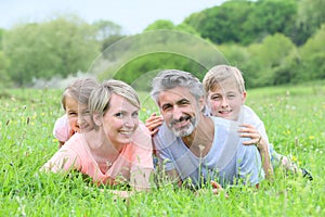 Portrait of family lying in grass