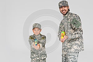 portrait of family in military uniform with water guns in hands