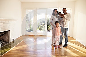 Portrait Of Family In New Home On Moving Day