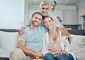 Portrait, family and relax on sofa in living room, smiling and bonding. Love, care and grandfather, man and woman