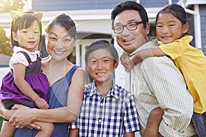 Portrait Of Family Standing Outside House