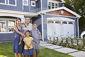 Portrait Of Family Standing Outside House