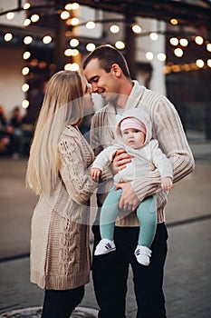 Portrait of family standing together in cosiness atmosphere.