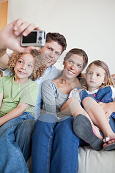 Portrait of a family taking a photo of themselves