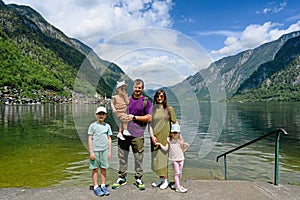 Portrait of family with three children over Austrian alps lake in Hallstatt, Salzkammergut, Austria