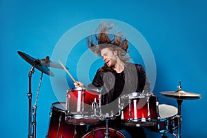 Portrait of famous artist man rocker play drum composition on stage concert tour hold drumstick wear leather jacket his